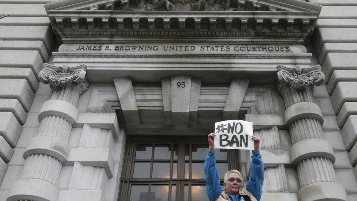 A protester outside the U.S. 9th Circuit Court of Appeals in San Francisco during a hearing over the Trump administration's appeal of a ruling staying the original travel ban.