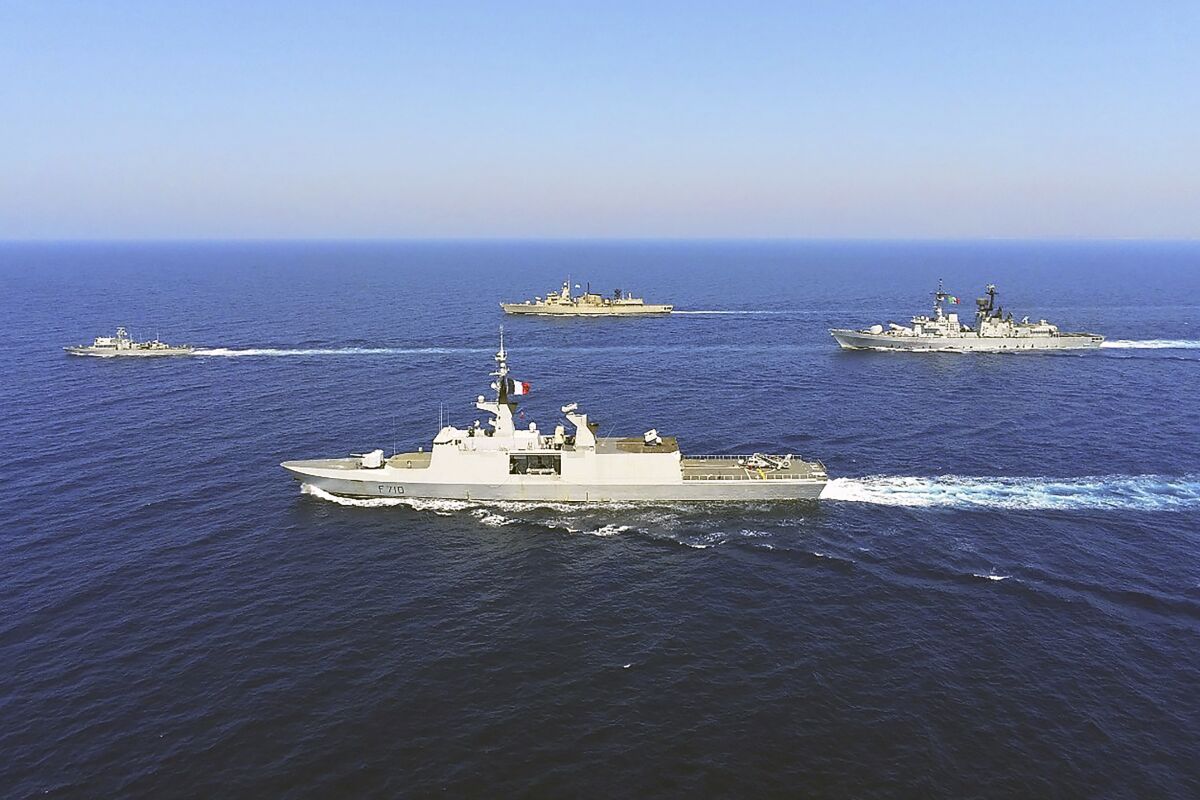 In this photo provided on Monday, Aug. 31, 2020, by the Greek Defense Ministry, warships from Greece, Italy, Cyprus and France, participate in a joint military exercise which was held from 26-28 of August, south of Turkey in eastern Mediterranean sea. Turkey on Monday, Aug. 31, accused Greece of "piracy" and warned it will stand up to Athens' alleged efforts to militarize islands near its coast. (Greek Defense Ministry via AP)