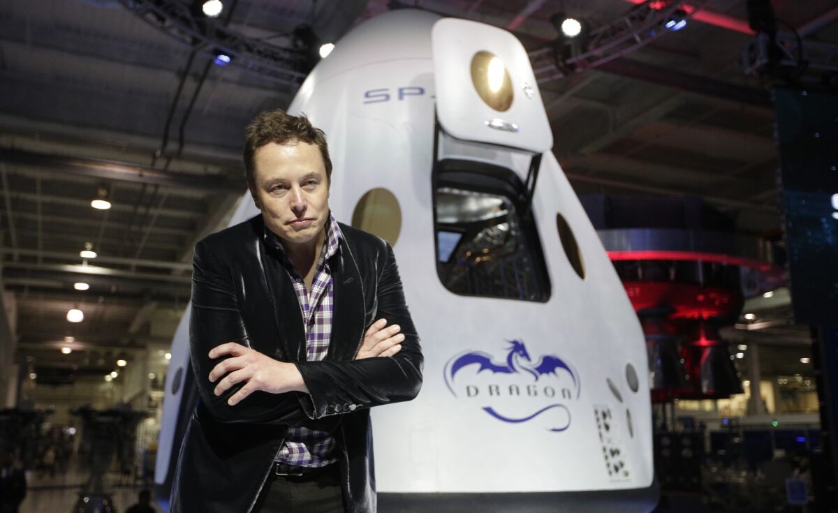 Tesla Motors and SpaceX CEO Elon Musk wants to build cars that can also fly and go underwater. Above, he stands in front of the SpaceX Dragon V2 spaceship at SpaceX's headquarters in May.