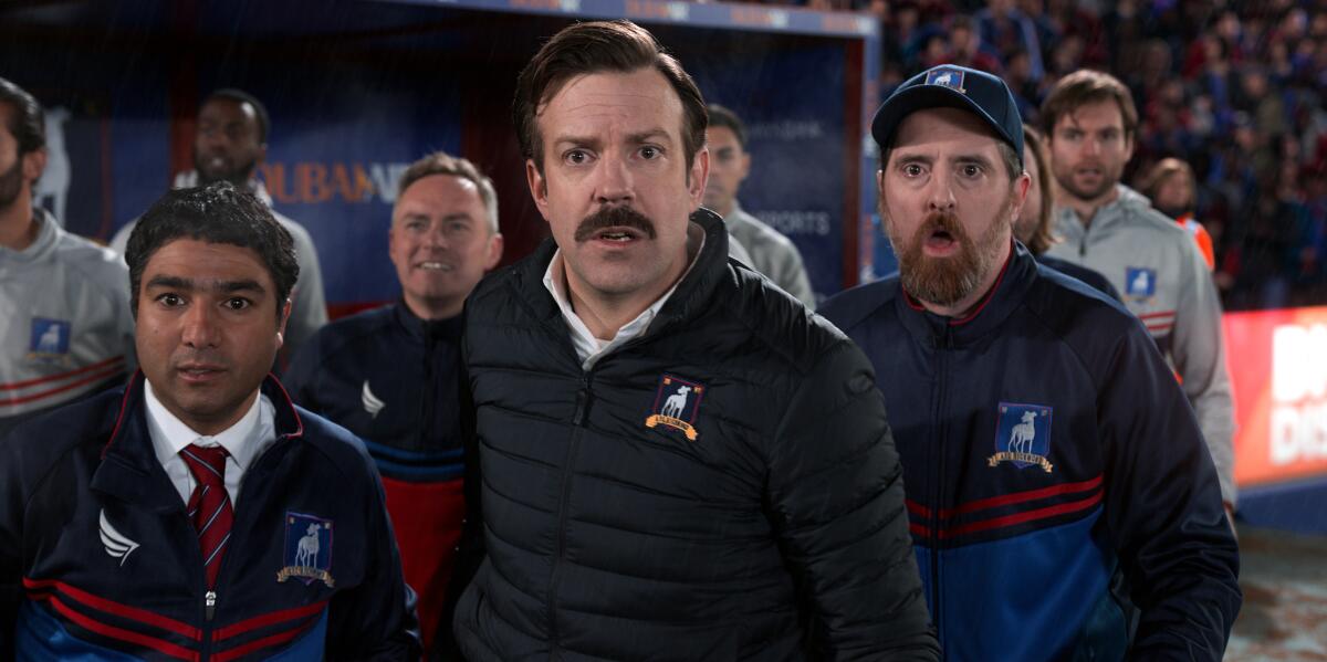 Nick Mohammed, Jason Sudeikis and Brendan Hunt look very surprised in "Ted Lasso."