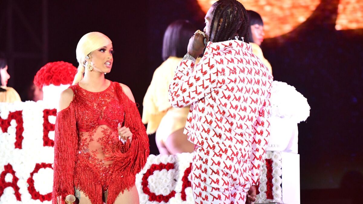 Singer Cardi B is presented a 'Take Me Back' card onstage by Offset during day 2 of the Rolling Loud Festival at Banc of California Stadium in Los Angeles.