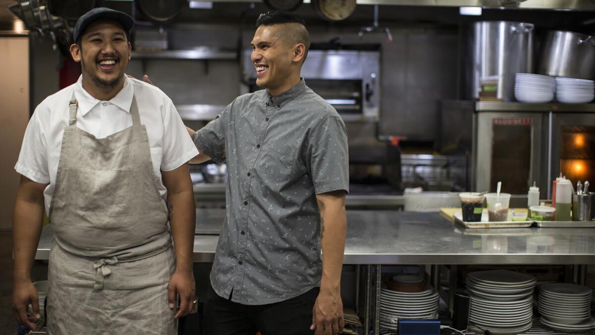 Chef Chad Valencia, left, and brother Chase Valencia in the kitchen at Lasa, a Filipino restaurant in Chinatown.
