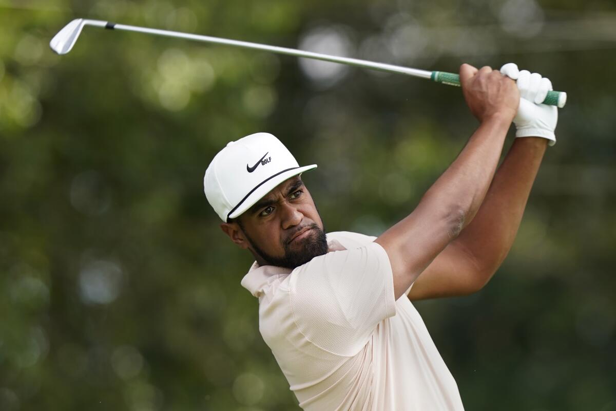 Tony Finau hits from the tee on the second hole during second-round play in the Tour Championship golf tournament at East Lake Golf Club, Friday, Sept. 3, 2021, in Atlanta. (AP Photo/Brynn Anderson)