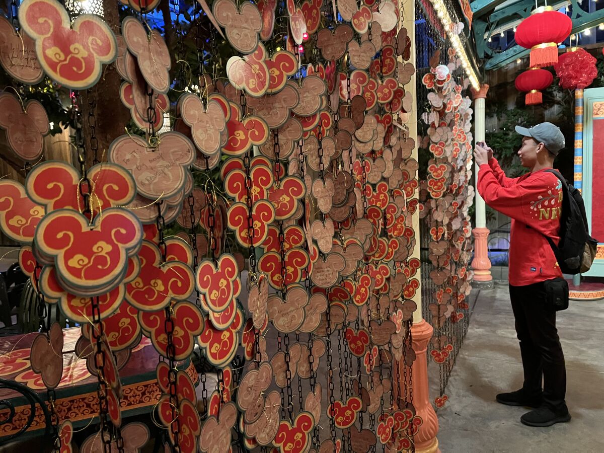 Stephen Tran makes a wish at the Lucky Wishes Wall at Paradise Gardens Park.