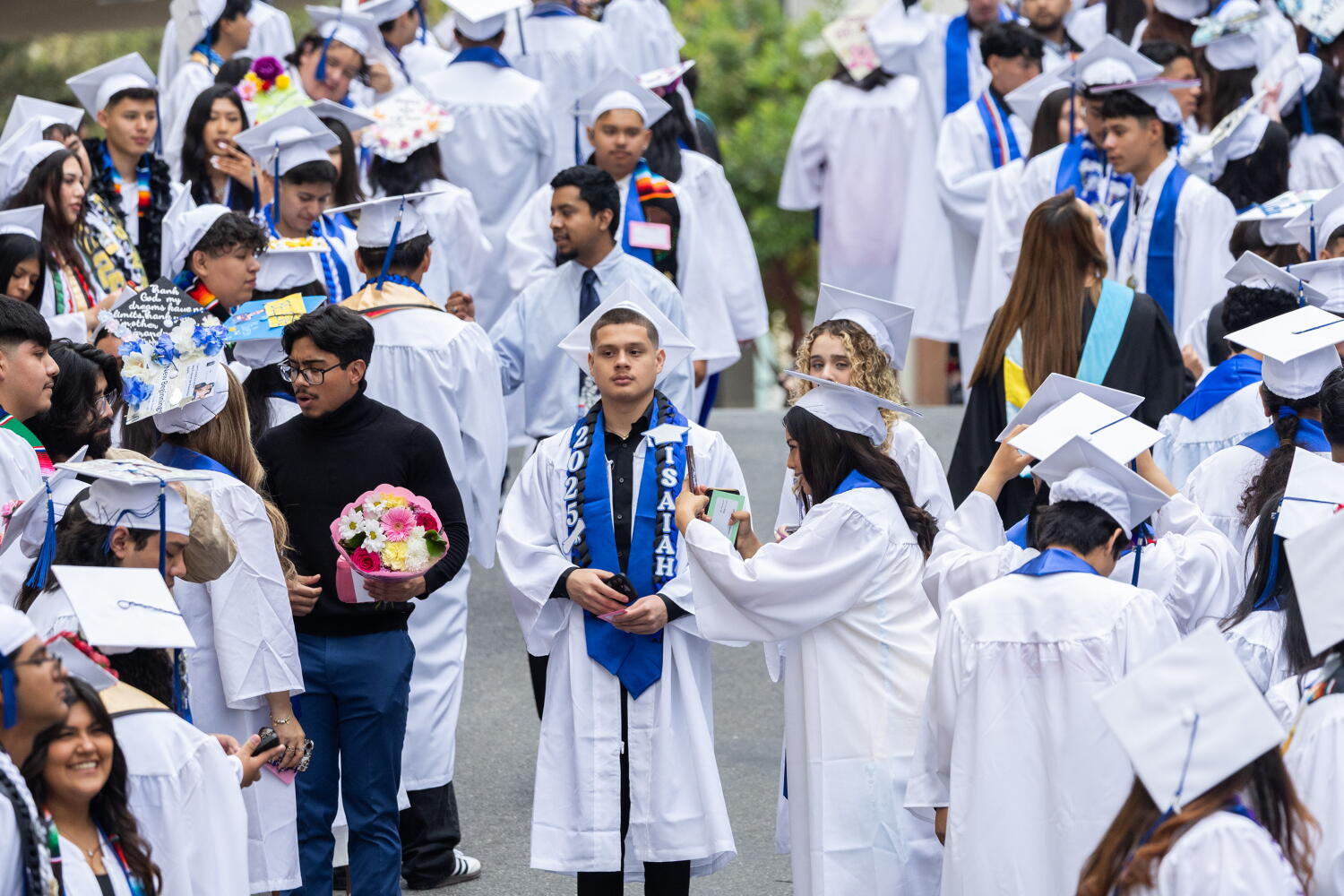 MONTEREY PARK, CA - JUNE 12: Maywood Academy High School students wait for the start of their graduation ceremony at East Los Angeles College in Monterey Park, CA on Thursday, June 12, 2025. (Myung J. Chun / Los Angeles Times)