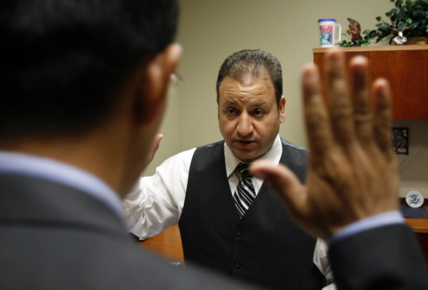 An asylum applicant takes an oath of honesty during an interview with U.S. Citizenship and Immigration Services asylum officer Farhad Zamani in Anaheim.