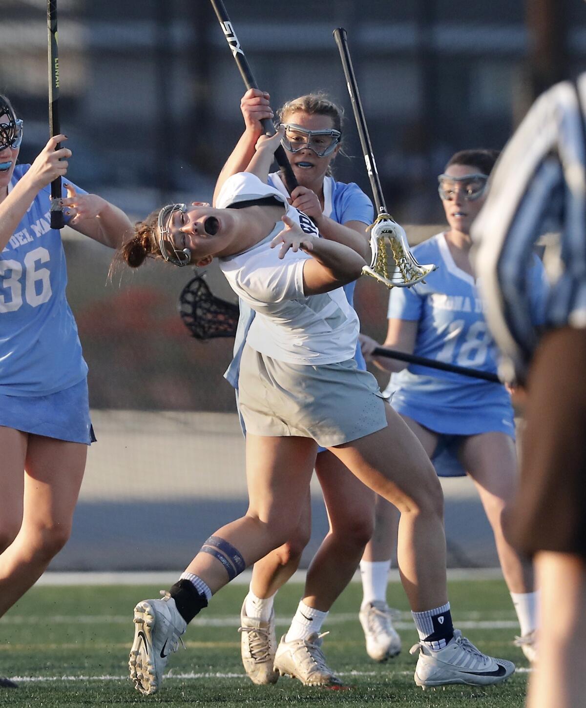 Corona del Mar High's Tessa Montgomery, top, is called for a yellow card with this hit on Newport Harbor's Mariana Miller, bottom, in the first half of a Sunset League game at Davidson Field on Thursday.