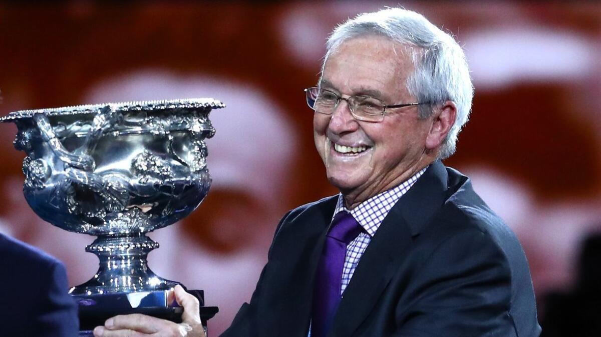 Roy Emerson poses with the Norman Brookes Challenge Cup before the men's singles final match at the 2019 Australian Open on Jan. 27.