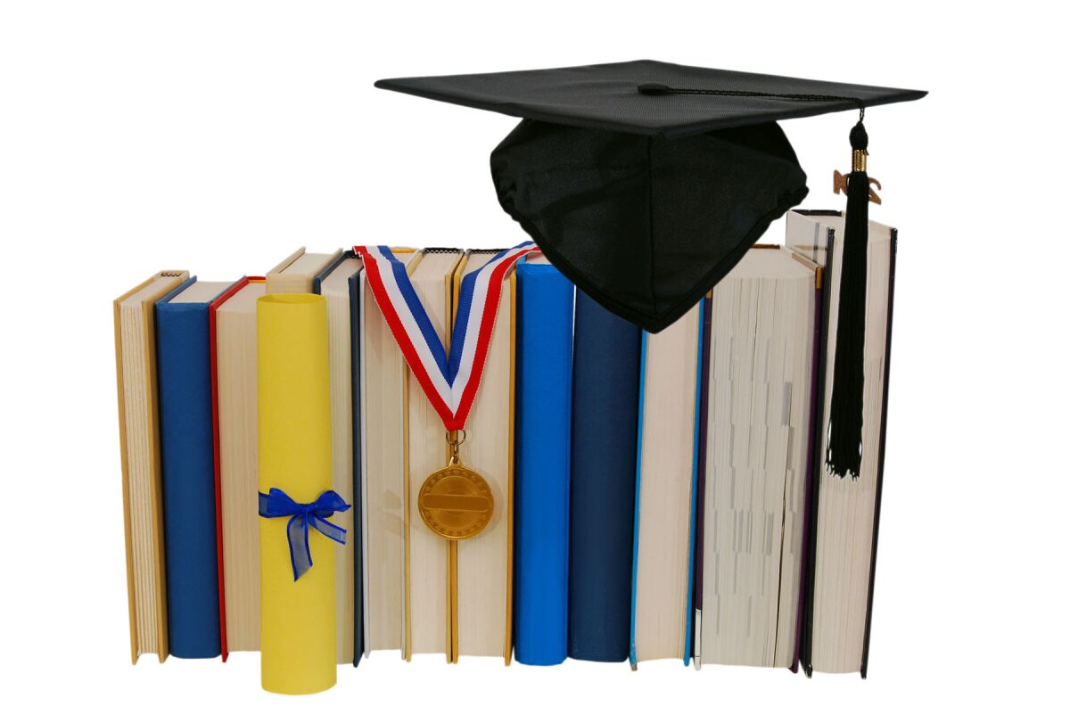 Cap graduation with medal, diploma and books
