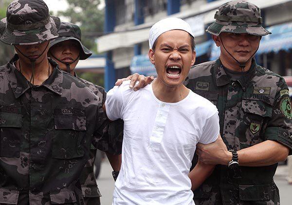 Dino Amor Pareja, a suspected ranking leader of the Al Qaeda-linked terrorist group Rajah Solaiman Movement, shouts "Allahu Akbar (God is Great!)" following his capture in the Philippines.