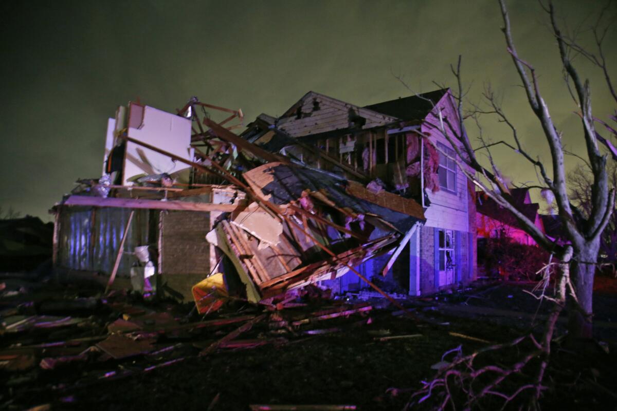 Debris lies near a home that was heavily damaged by a tornado in Rowlett, Texas.