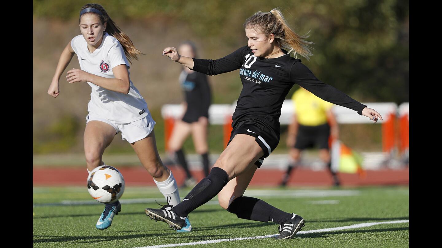 Corona del Mar High's Elizabeth Lamie, right, kicks the ball during the first half against Beckman in a Pacific Coast League game on Thursday.