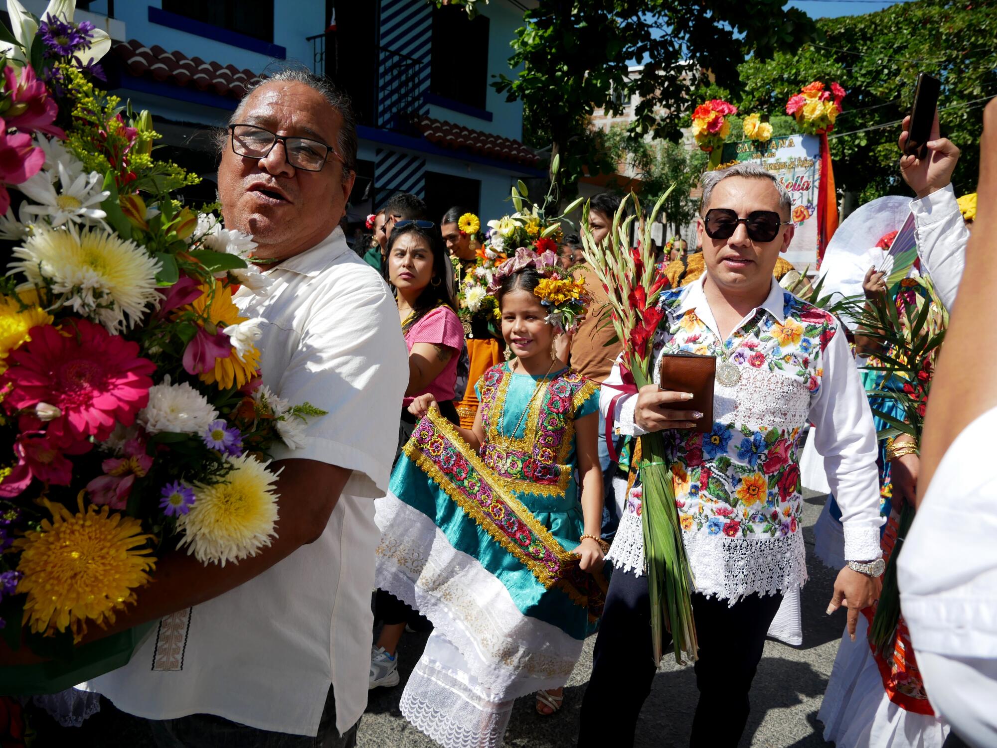 Multigenerational crowds of attendees carry flowers as tributes in Juchitan de Zaragoza, Oaxaca, Mexico on Nov. 18.