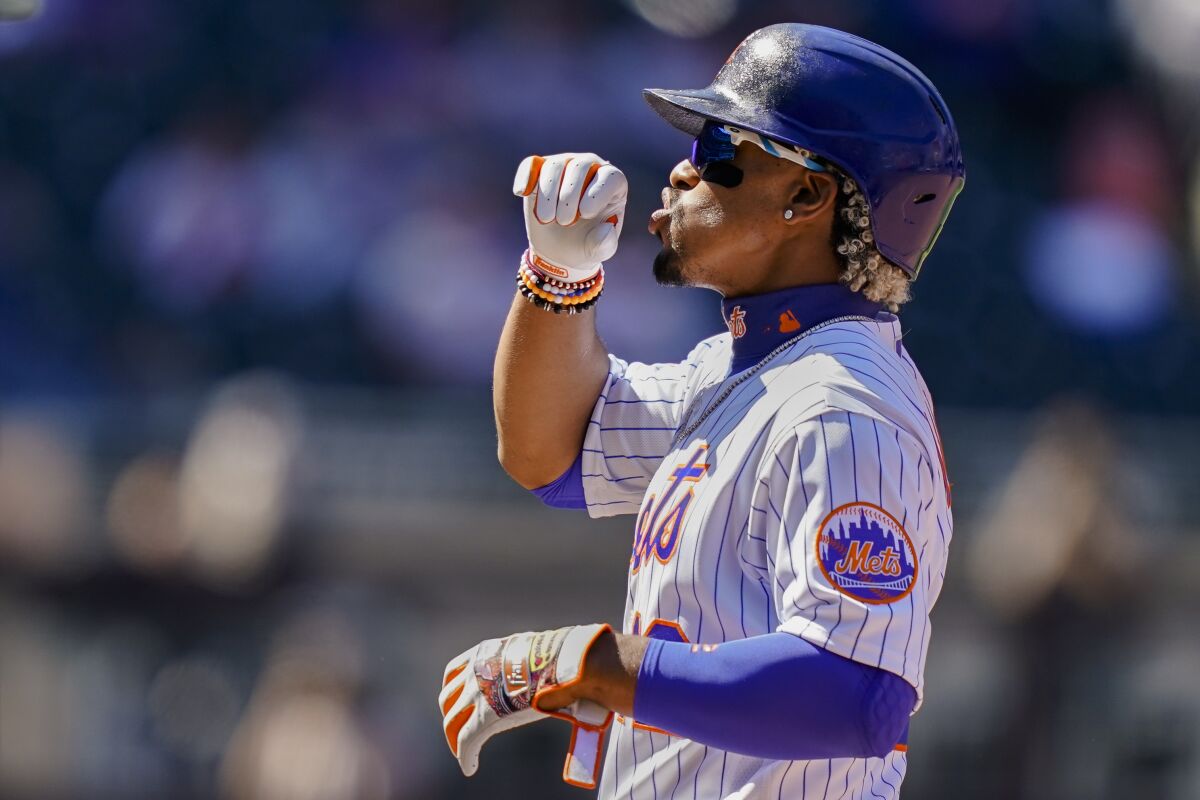 New York Mets' Francisco Lindor reacts after hitting a single off Miami Marlins relief pitcher Nick Neidert during the fifth inning of a baseball game, Thursday, April 8, 2021, in New York. (AP Photo/John Minchillo)