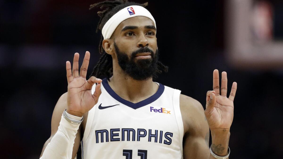 Grizzlies point guard Mike Conley reacts after making a three-point shot against the Clippers during the second half Friday.