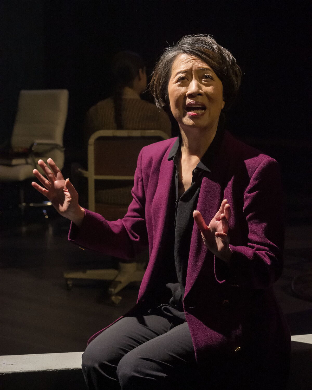 Jeanne Sakata gestures as she speaks while seated on a bench in "Twilight: Los Angeles, 1992"