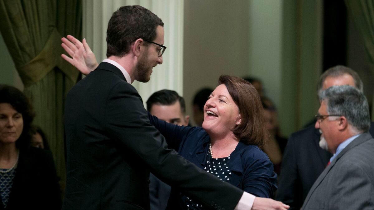 State Sen. Toni Atkins (D-San Diego) receives congratulations from Sen. Scott Wiener (D-San Francisco) after her housing measure was approved by the state Assembly on Thursday.