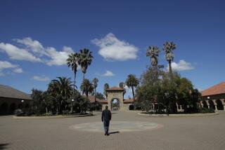 In this April 9, 2019 photo, a pedestrian walks on the campus at Stanford University in Stanford, Calif. (AP Photo/Jeff Chiu)