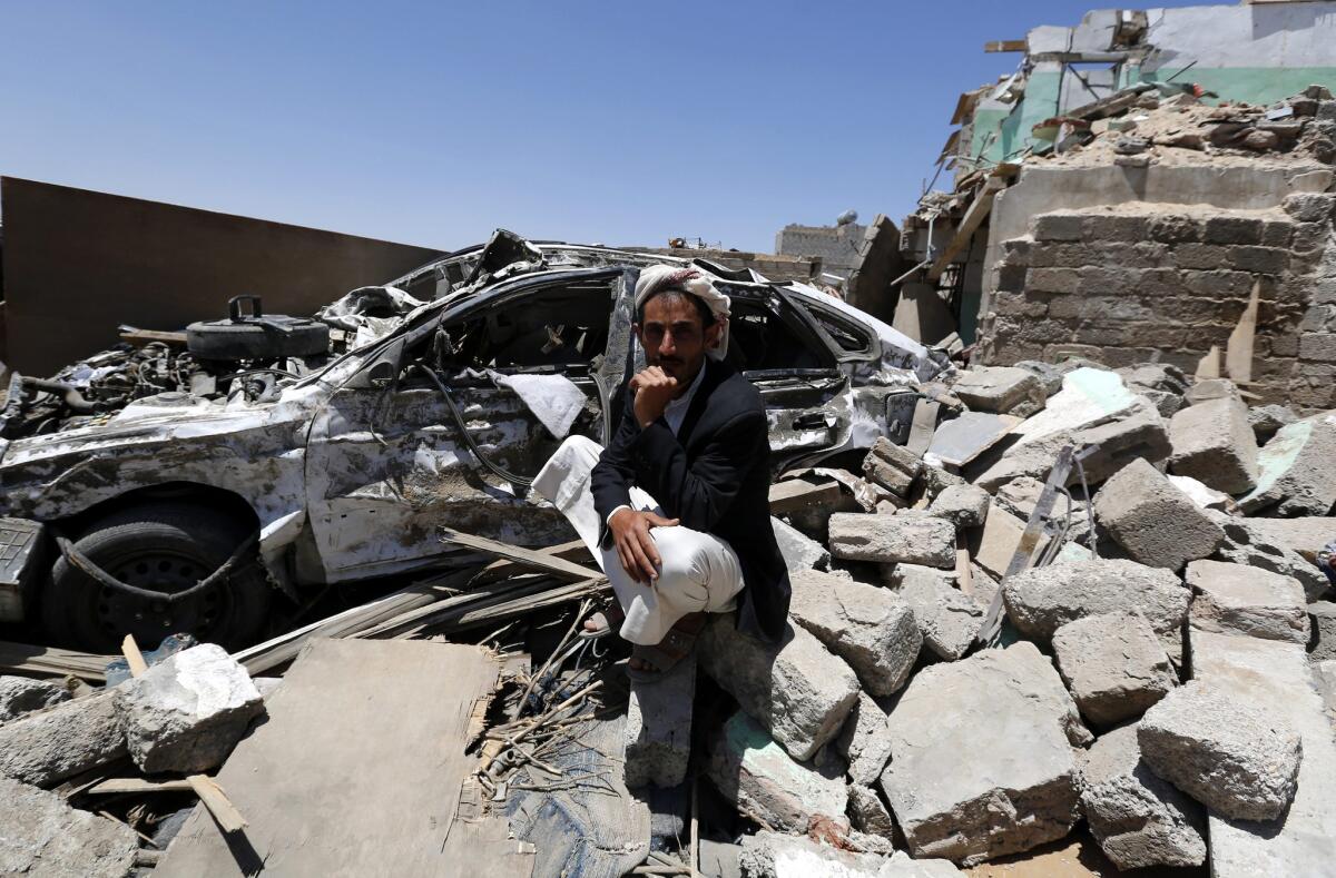 A Yemeni man sits beside his car and over the rubble of his house that was allegedly destroyed by an airstrike of the Saudi-led coalition targeting Houthi rebel positions in Sana, Yemen, on March 28.