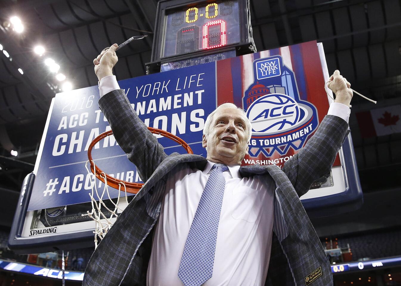 North Carolina Coach Roy Williams holds part of the net after his Tar Heels defeated Virginia in the ACC championship game on March 12.