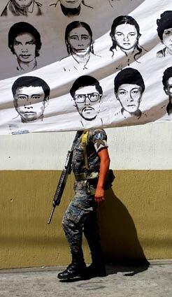 A banner showing images of people who disappeared during the 36 years of internal conflict in Guatemala between leftists guerrillas and military dictatorships puts a new face on military activity there. Human rights protesters in Guatemala City are demanding public access to military archives, which they say could reveal evidence of genocide.