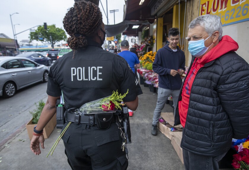 A police officer walks in the Flower District