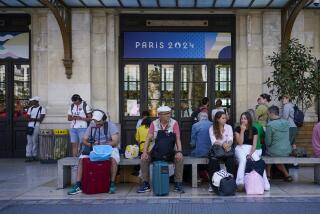 Travelers wait outside the Gare de Bordeaux Saint-Jean at the 2024 Summer Olympics, Friday, July 26, 2024, in Bordeaux, France. Hours away from the grand opening ceremony of the Olympics, high-speed rail traffic was severely disrupted. (AP Photo/Moises Castillo)