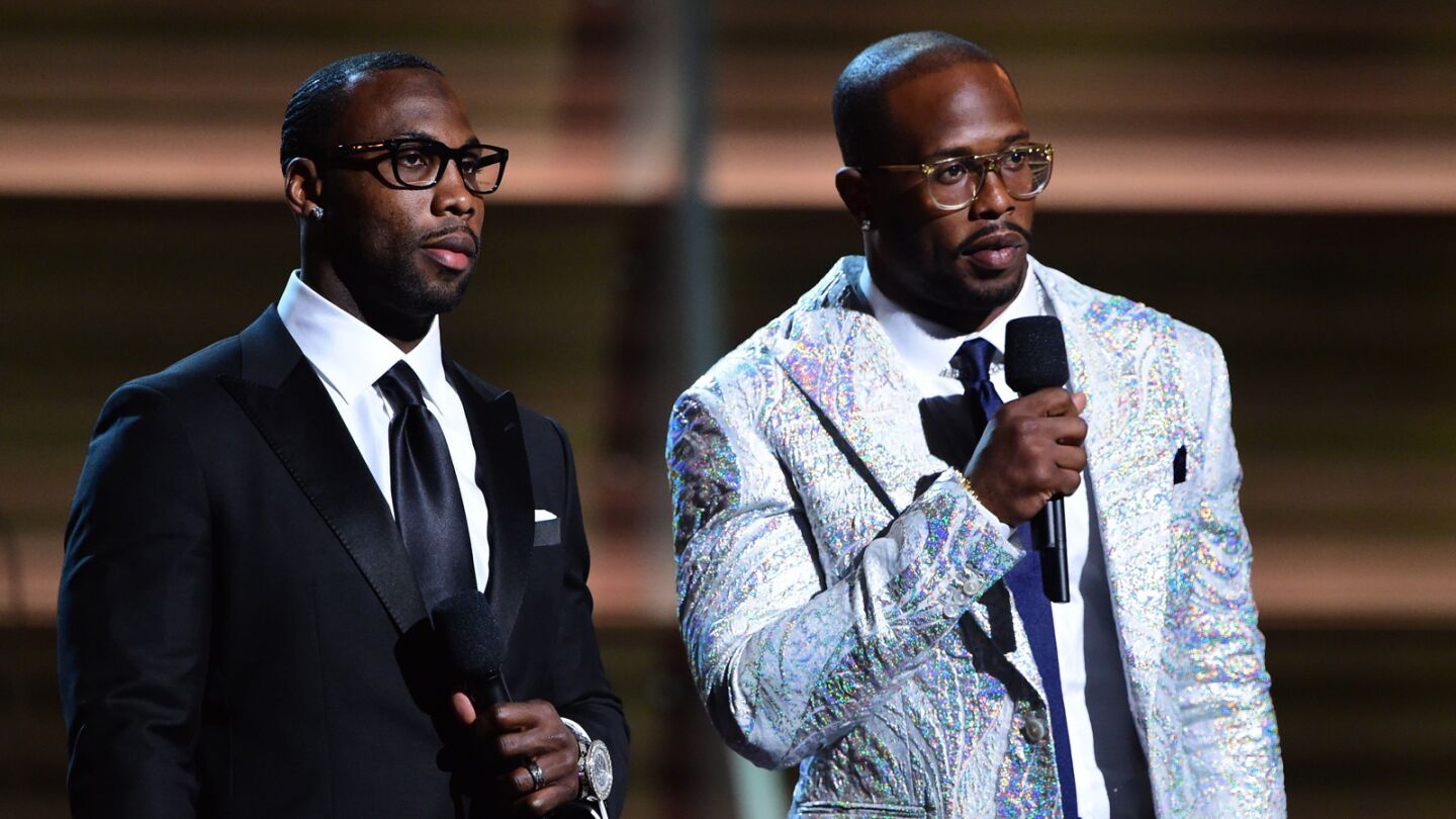 NFL player Anquan Boldin and NFL player Von Miller announce nominees onstage.