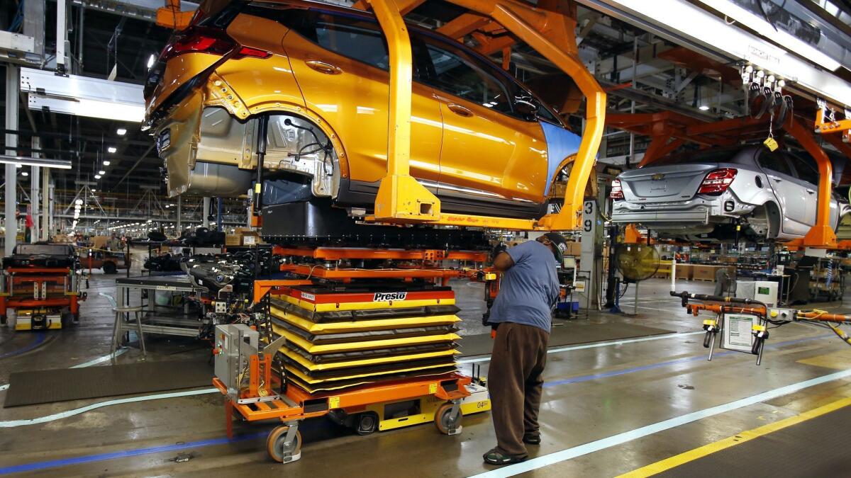 A Chevrolet Bolt, the company's electric vehicle, is fitted with a battery at a GM assembly plant in Michigan.