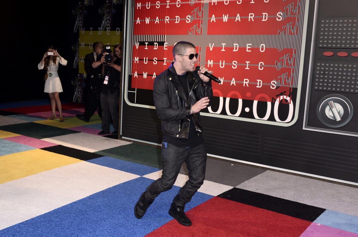 Nick Jonas performs on the red carpet for the 32nd MTV Video Music Awards.