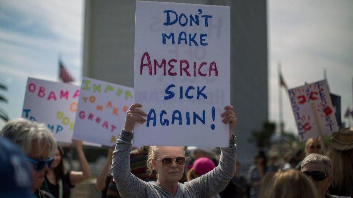 People protest Trump administration attempts to dismantle the Affordable Care Act near the Wilshire Federal Building in Los Angeles in 2017.