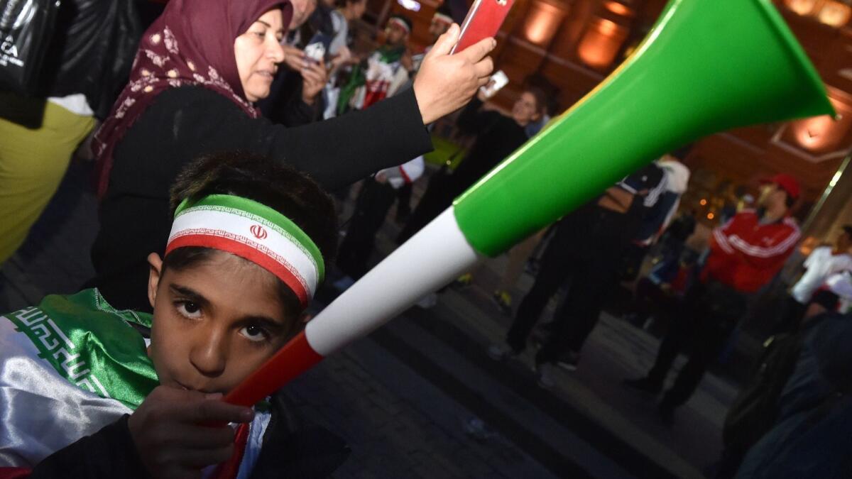 An Iranian fan cheers outside the Kremlin on June 11
