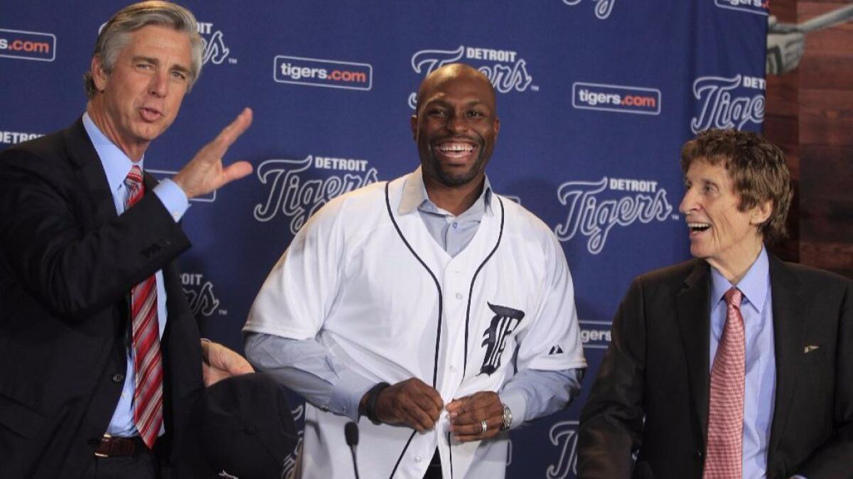 Tigers owner Mike Ilitch, right, smiles with outfielder Torii Hunter and General Manager David Dombrowski, right, before a news conference in Detroit on Nov. 16, 2012.