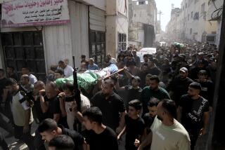 Gunmen march during a funeral with the bodies of Palestinians Ahmed Abu Arra from the town of Aqaba, left, and Raafat Dawasa from the town of Silat Al-Harithiya, both draped in the Hamas flag and killed in an Israeli strike in the Jenin refugee camp, in the West Bank city of Jenin, Sunday, Aug. 18, 2024. Israel's military said Saturday it struck a "terrorist cell" in Jenin. The Palestinian health ministry there said two bodies were taken to a government hospital; Hamas claimed the two men as commanders in its military wing. (AP Photo/Majdi Mohammed)