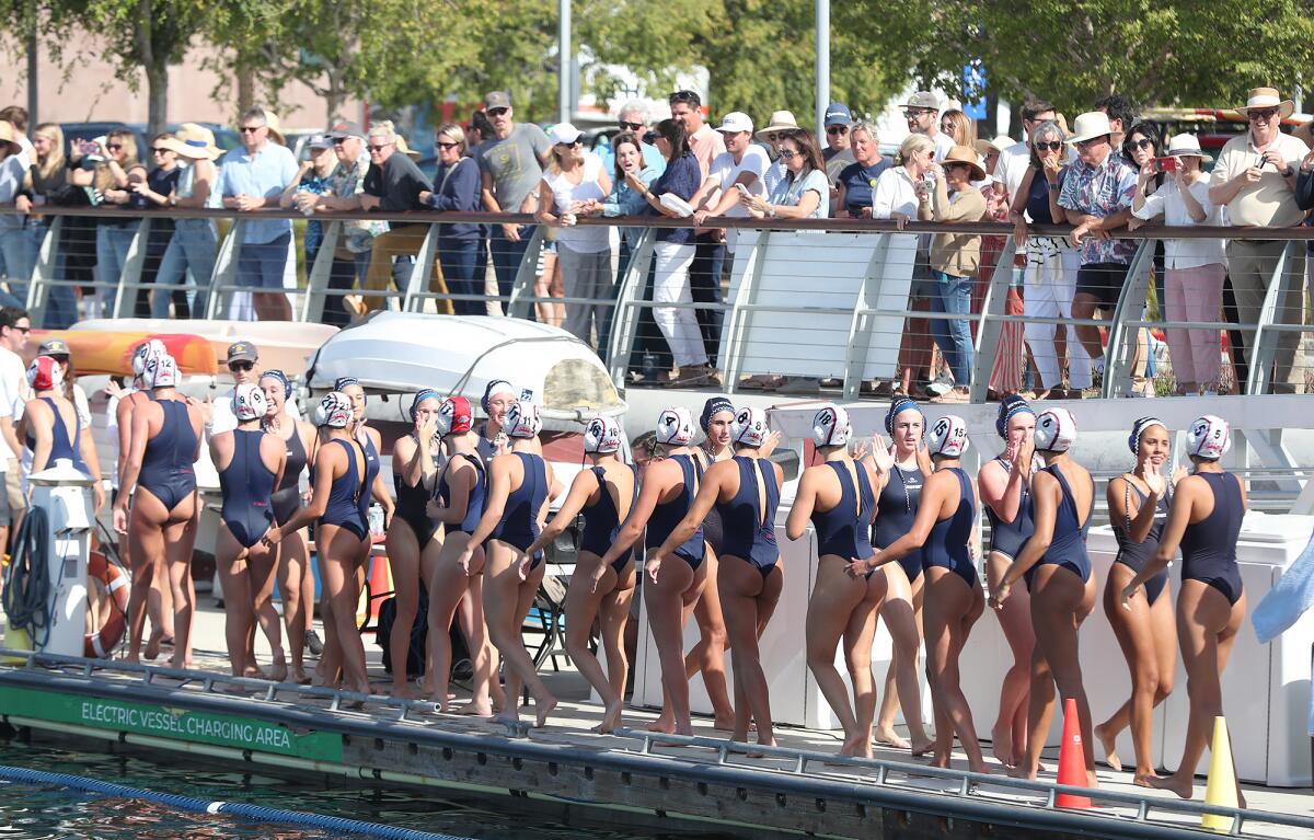 Members of the Newport Harbor and Corona del Mar girls water polo teams shake hands after the game on Thursday.