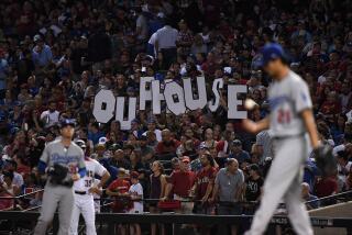 Arizona Diamondbacks fans hold up a sign during a playoff game against the Dodgers on Oct. 9, 2017, in Phoenix.