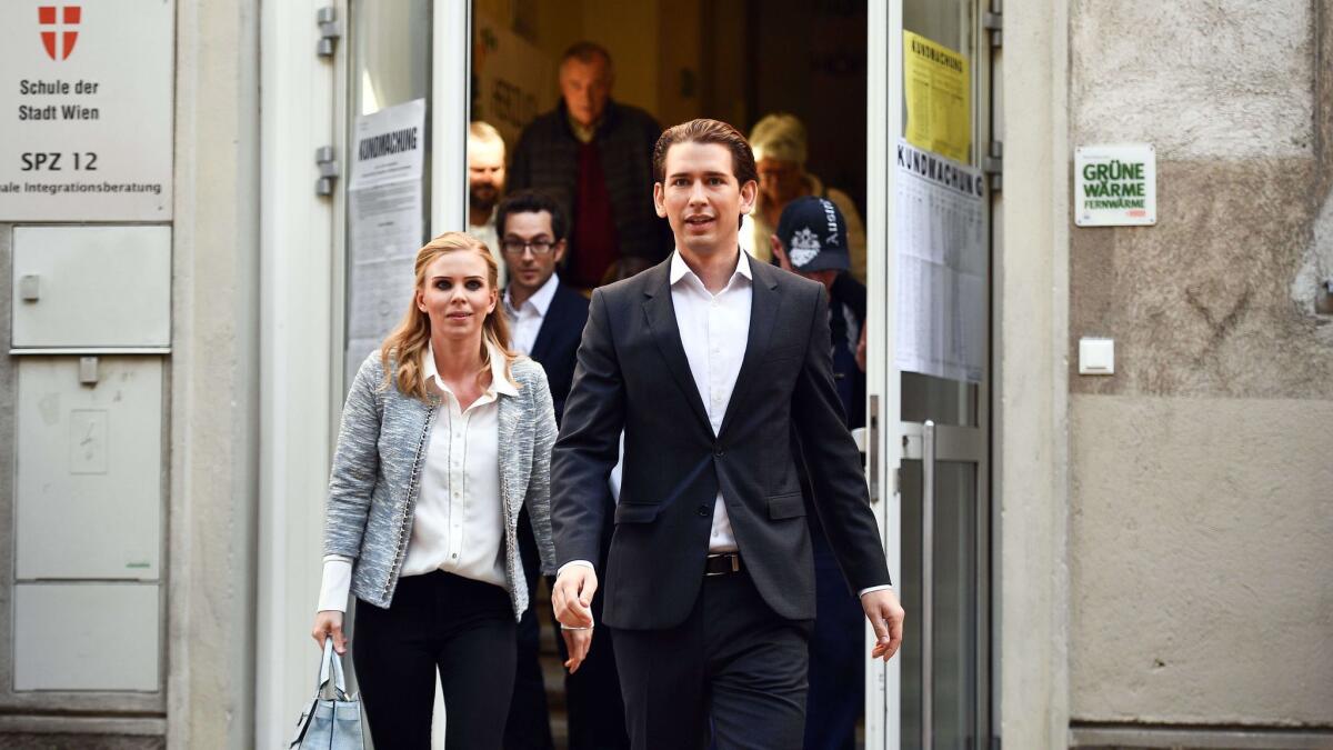 Austrian Foreign Minister Sebastian Kurz and his girlfriend, Susanne Thier, leave a polling station after casting their votes in the Austrian Federal Elections in Vienna on Sunday.