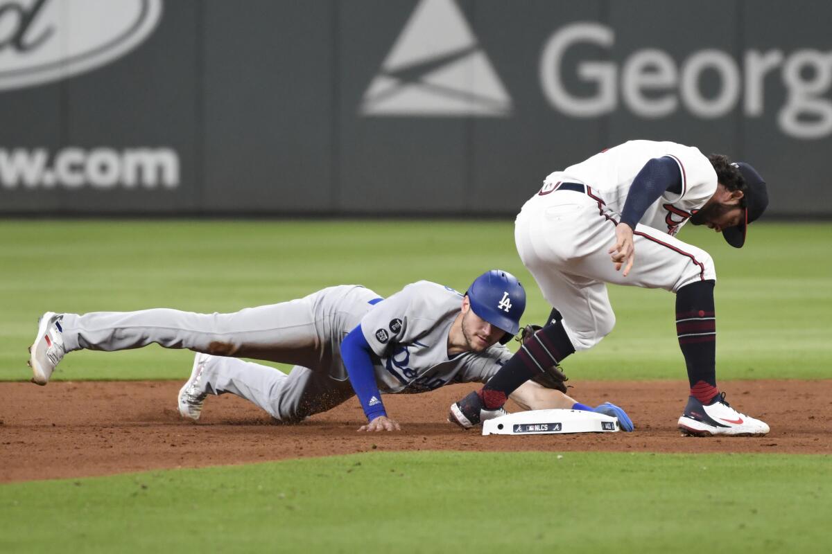 Trea Turner of the Dodgers steals second ahead of the tag of Dansby Swanson of the Atlanta Braves in the 2021 NLCS.