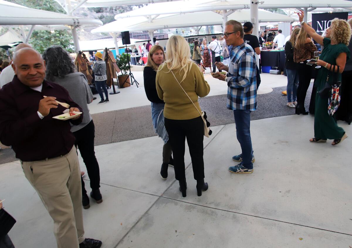 Guests enjoy samples of delicious dishes during the Taste of Laguna Food and Music Festival on Thursday.