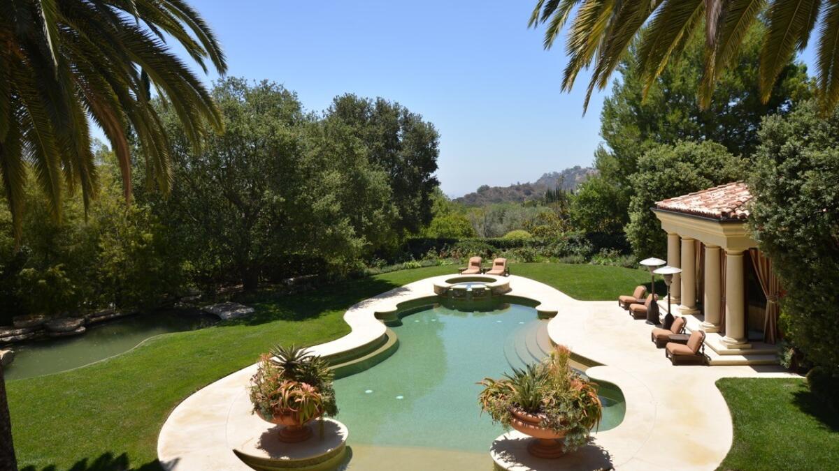 A swimming pool with a raised spa are among amenities found on the 1.8-acre grounds.