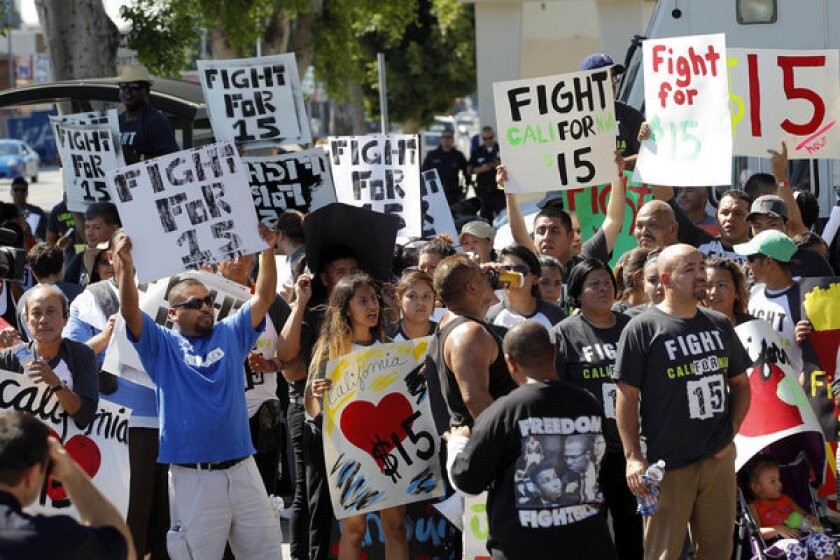 Protesters demonstrate outside a fast-food restaurant in Los Angeles. Thousands of fast-food workers and their supporters have been staging protests across the country to call attention to the struggles of living on or close to the federal minimum wage. The push raises the question of whether the economics of the fast-food industry allow room for a boost in pay for its workers.
