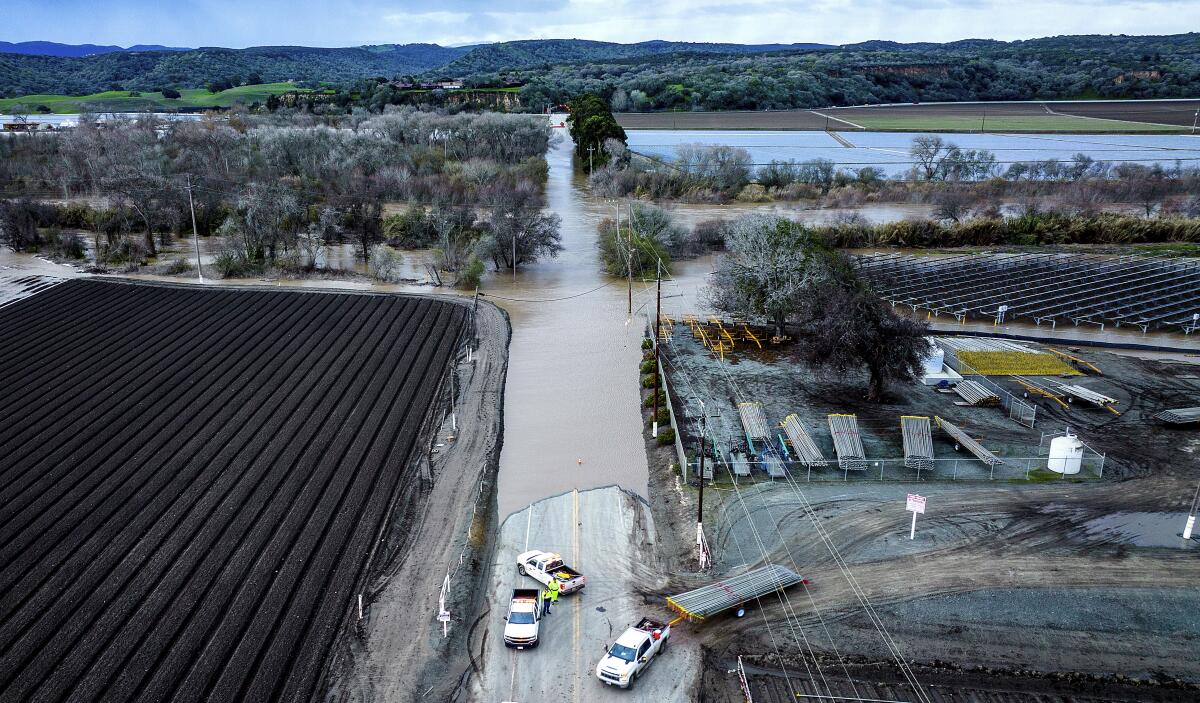 Floodwaters cover South Davis Rd. near Salinas in Monterey County, Calif., as the Salinas River overflows its banks on Friday, Jan. 13, 2023. (AP Photo/Noah Berger)