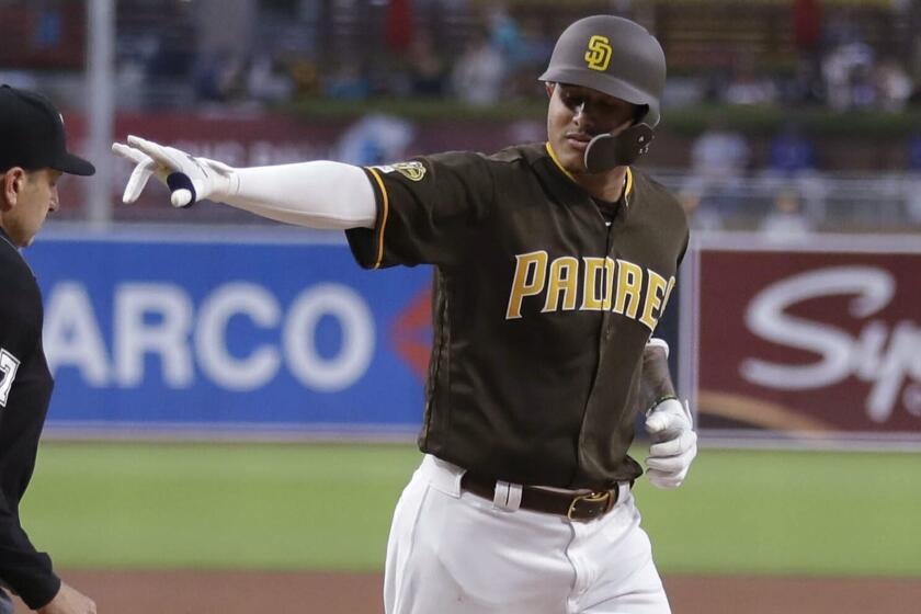 San Diego Padres' Manny Machado gestures as he rounds the bases after hitting a two-run home run during the first inning of a baseball game against the Los Angeles Dodgers on Friday, May 3, 2019, in San Diego. (AP Photo/Gregory Bull)