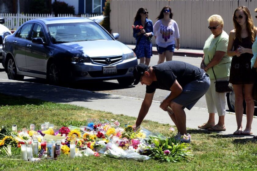 People pay their respects at the Alpha Phi sorority in Isla Vista, where two young women were killed in Friday's rampage.