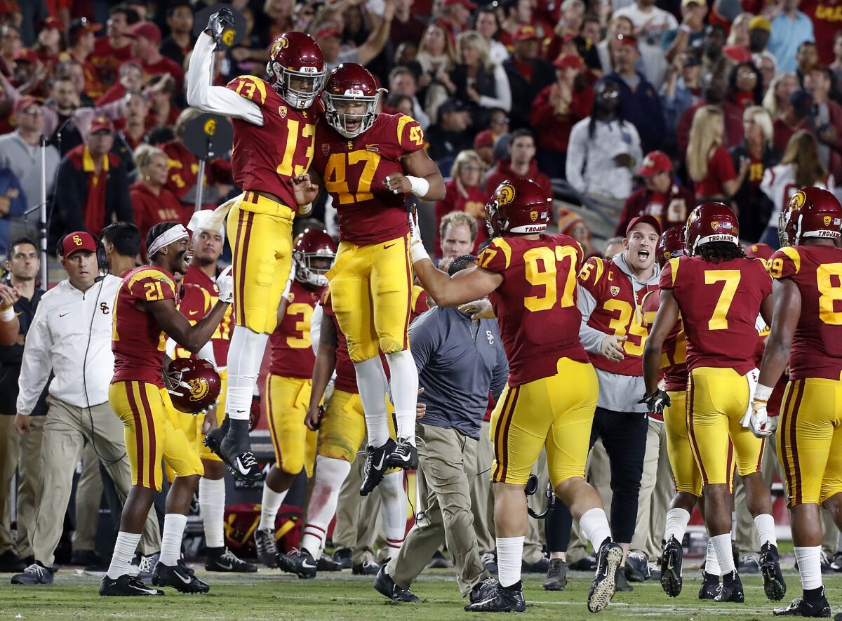 The USC sideline celebrates after the Trojans defense forced Colorado to turn the ball over on Oct. 13.