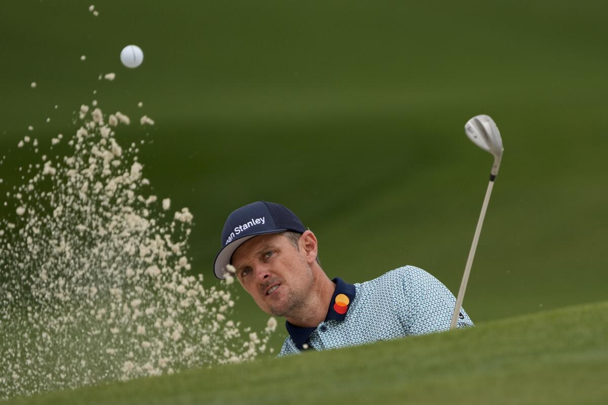 Justin Rose hits out of a bunker on the seventh hole during the second round of the Masters on Friday.