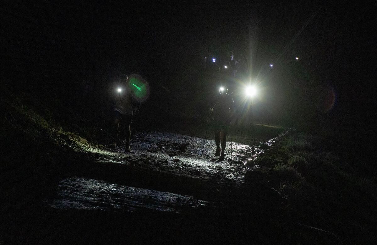  Spectators use headlamps to guide the way out of Olympic Valley