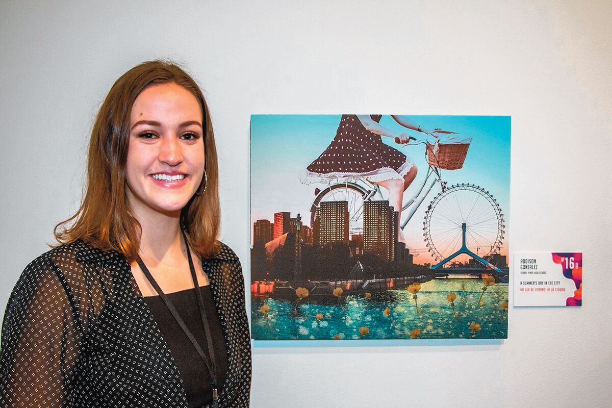 At the Oct. 12, 2019 opening of ‘Dreamscapes,’ Addison Gonzalez, now a senior at Torrey Pines High School, poses with ‘A Summer’s Day in the City' at Museum of Photographic Arts in Balboa Park, San Diego.
