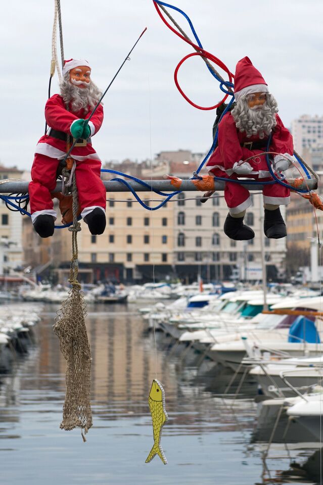 Santa's gone fishin'! Puppets adorned with fishing rods help decorate the port of Marseille in time for the holidays.