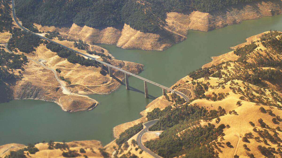 Highway 49 crosses over the New Melones Reservoir in the central Sierra Nevada foothills. On Monday, the reservoir was just 24% full, 40% of its historical average.